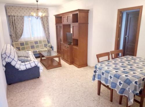 コニル・デ・ラ・フロンテーラにあるApartamento Villamartínのベッドルーム1室(ベッド1台、テーブル、椅子付)