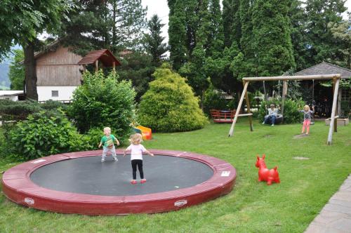 a group of children playing on a trampoline at Restaurant Gästehaus Wiesenheim in Uderns