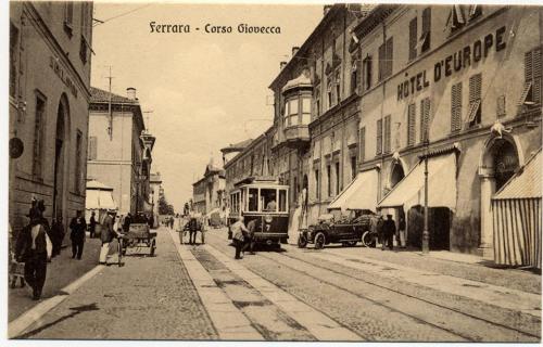 an old photo of a city street with cars and people at Hotel Europa in Ferrara