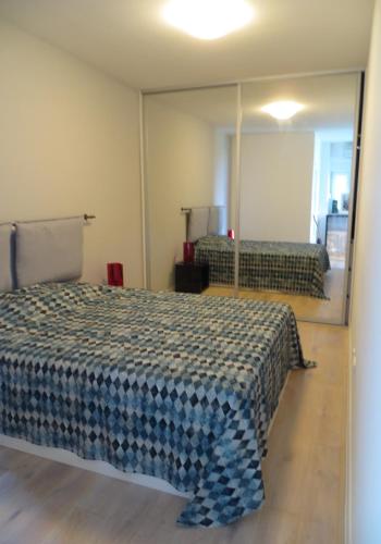 a bedroom with a bed and a mirror at Apartment Andrija in Baška Voda