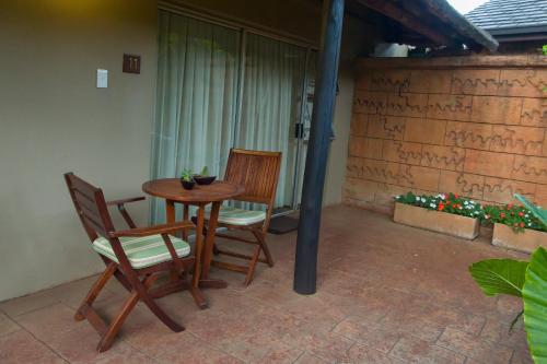 a table and chairs sitting on a patio at Bayswater Lodge in Bloemfontein
