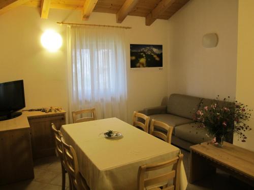 a living room with a table and a couch at Il Cardo Trentino in Bedollo