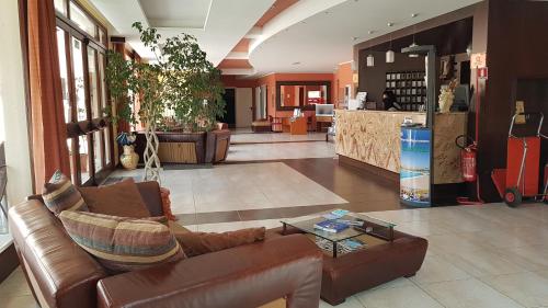 a living room with a couch and a table at Villa Zina Family Resort in Custonaci