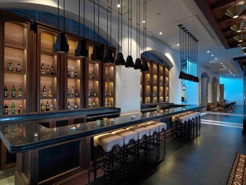 a bar in a restaurant with stools at Unico Hotel Riviera Maya Adults Only in Akumal