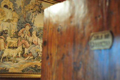 a painting on the wall next to a wooden door at Hotel Emblemático San Marcos in Icod de los Vinos