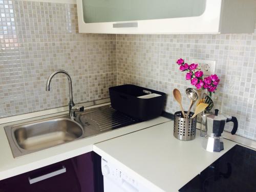 a kitchen counter top with a sink and a sink at Apartments Baričević in Bol