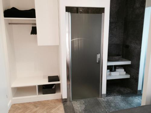 a bathroom with a glass shower door in a room at Hotel Lindenhof in Düsseldorf