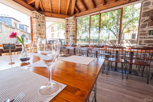 a table with wine glasses sitting on top of it at Hotel Rural La Bolera in Robles de Laciana