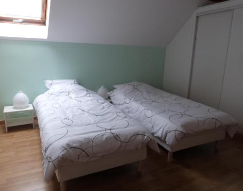 塞納河畔羅米伊的住宿－La petite maison de Lilou，一间卧室设有两张床和窗户。