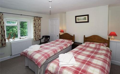 two beds sitting next to each other in a bedroom at Zeal Farm in Dulverton