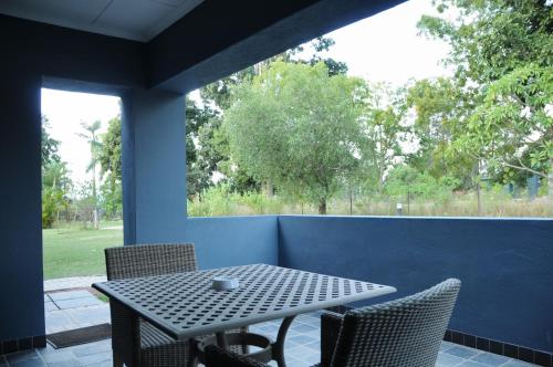 a table and chairs on a patio with a window at ilanda Guest House in White River