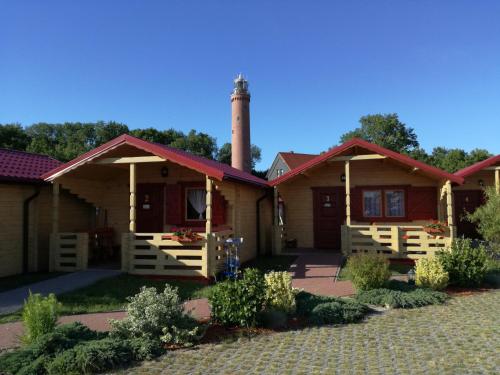 dom z wieżą na górze w obiekcie Domki drewniane OW Latarnik w Gąskach