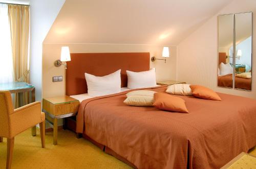 a hotel room with a large bed with two pillows at Restaurant-Hotel Maien in Lörrach