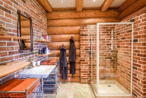 a brick bathroom with a sink and a shower at Sunset House in Ulmale