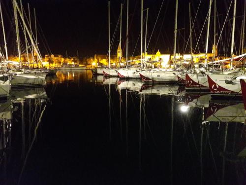 a group of boats docked in a harbor at night at Villa Tudor in Trogir