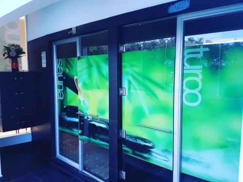 two glass doors in a building with a car on it at Hotel Florida Sinú in Montería