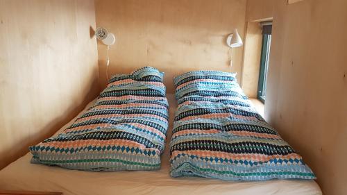 two pillows sitting on top of a bed at Gamtunet Lyngen in Svensby
