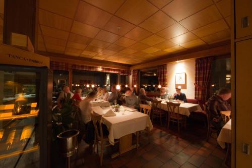 a group of people sitting at tables in a restaurant at Restaurant-Hotel Maien in Lörrach