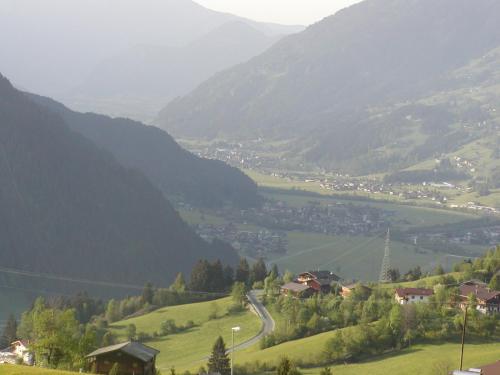 a view of a valley with a town on a hill at Ferienwohnungen Rieser in Hainzenberg