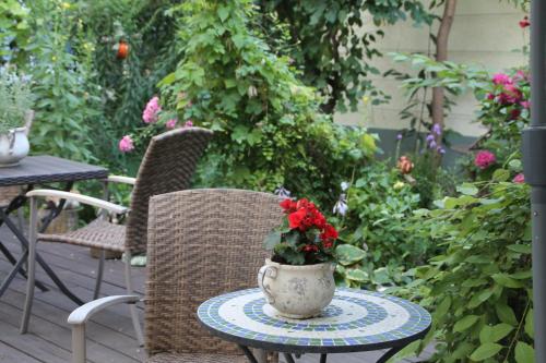 a table with a vase of flowers on a patio at Trip Inn Hotel Zum Riesen Hanau in Hanau am Main