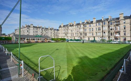a soccer field in front of a large building at Comely Bank Apartment in Edinburgh