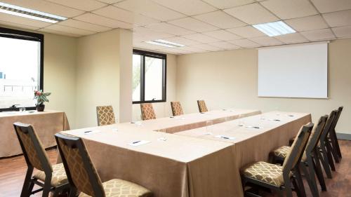 a meeting room with a long table and chairs at Mak Albania Hotel in Tirana