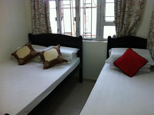 Tempat tidur dalam kamar di Hung Fai Guest House