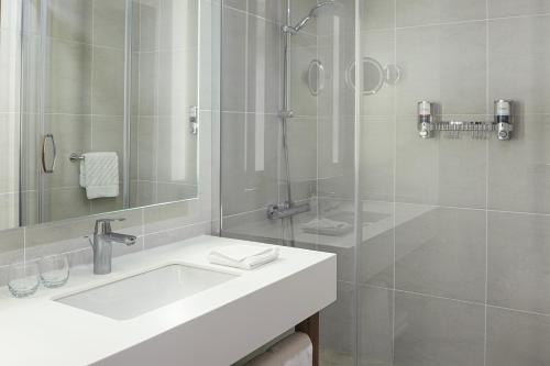 a white bathroom with a sink and a shower at Bof Hotels Business in Istanbul