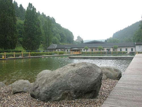a large rock sitting on top of a body of water at Pension / Ferienwohnung Allebrodt in Lennestadt