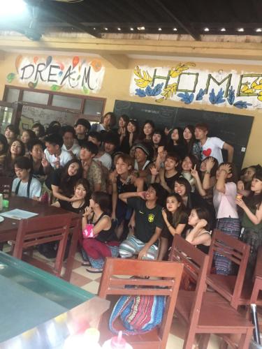 a group of people posing for a picture in a classroom at Dream Home Hostel in Vientiane
