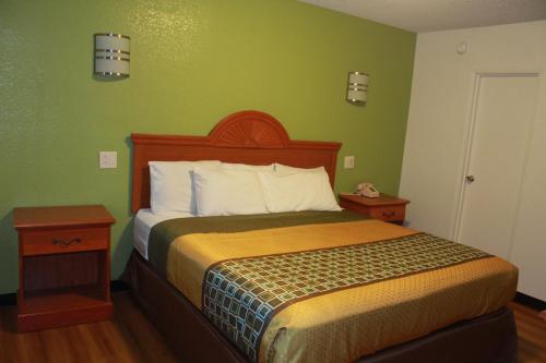 a bedroom with a bed and a green wall at Royal Inn in Mount Vernon