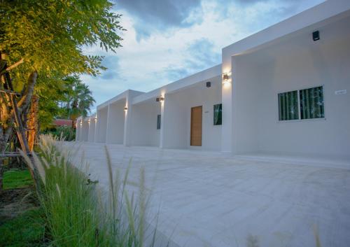 a large white building with lights on it at West View Villa in Kanchanaburi