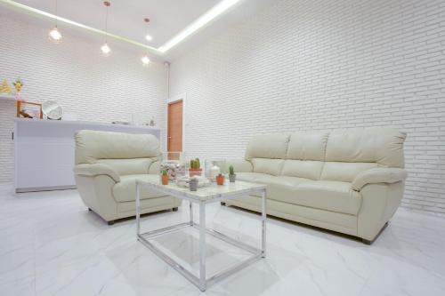 a living room with a couch and a table at West View Villa in Kanchanaburi
