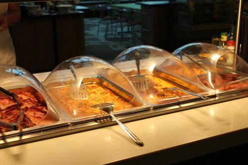 a buffet line with many dishes of food in domes at Toila Spa Hotel in Toila