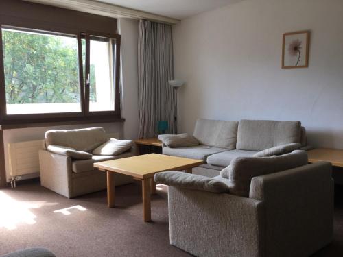 a living room with two couches and a table at Disentis in Disentis