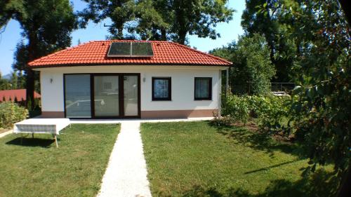 a white house sitting in front of a house at Rooms & Apartment Mira G. in Postojna