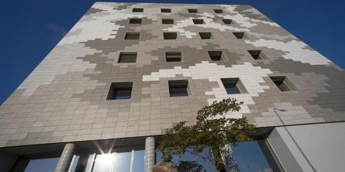 a building with a large pixelated building at Hotel The Cube in Fidenza