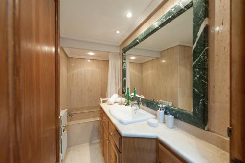 a bathroom with a sink and a large mirror at Can Gual in Inca