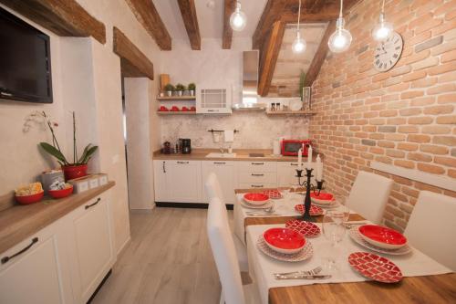 a kitchen with a table and a brick wall at Ca del Pape in Venice