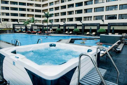 a jacuzzi tub in front of a building at The Garden Hotel Guangzhou - Discover 26 cultural treasures with hotel Golden Tour Guide in Guangzhou