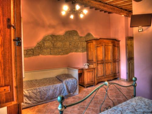 a bedroom with two twin beds and a stone wall at Agriturismo Podere Del Lepre in San Quirico