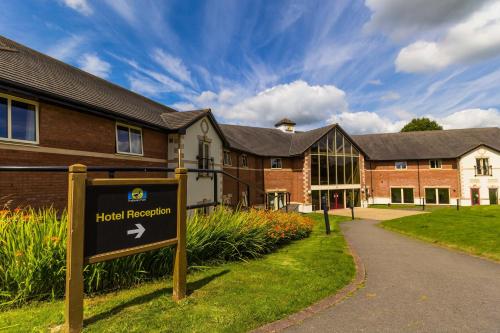 a hotel reception sign in front of a building at Padbrook Park Hotel in Cullompton