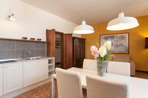 a kitchen with a table with a vase of flowers on it at Palazzo Valmarana Braga in Vicenza