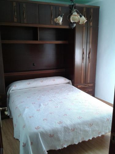 a bedroom with a bed with a wooden headboard at Casa Flori in Celorio