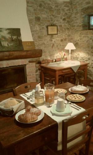 a wooden table with food on top of it at Cascina Formighezzo in Arquata Scrivia