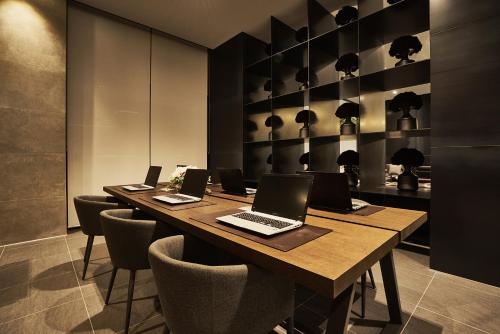 a conference room with a table with laptops on it at Royal Emporium Incheon Airport in Incheon