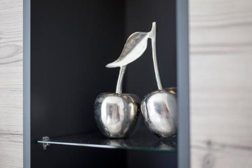 two metal vases sitting on a glass shelf at Aparthotel Backstage in Kufstein