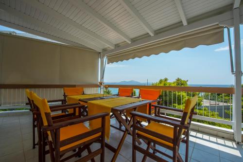 a balcony with tables and chairs and a view at Starapartment Athens-Varkiza Top 1 in Varkiza