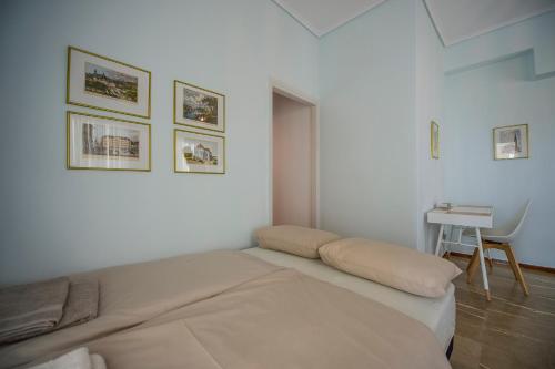 a white bedroom with a bed and a desk at Starapartment Athens-Varkiza Top 1 in Varkiza