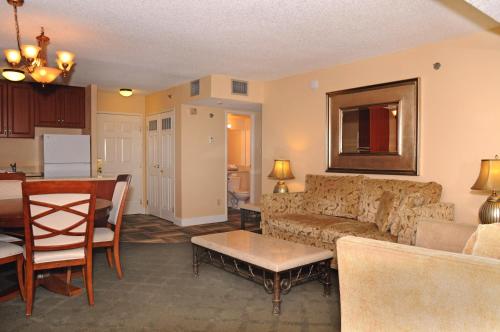 a living room with a couch and a table at Jockey Resort Suites Center Strip in Las Vegas